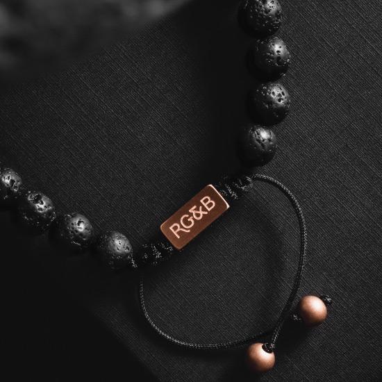 Lava Stone Bead Bracelet - Our Lava Stone Bead Bracelet Features Natural Stones, Waxed Cord and Brushed Rose Gold Steel Hardware, Engraved with the Signature RG&B Logo.